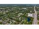 A beautiful aerial view of the neighborhood, showcasing homes and the nearby highway at 135 Tall Trees Ct, Sarasota, FL 34232