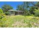 Beautiful backyard with verdant landscaping, healthy lawn, and a screened-in porch for outdoor enjoyment at 135 Tall Trees Ct, Sarasota, FL 34232