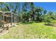 Well-maintained backyard with a spacious lawn and a screened-in patio, perfect for relaxation and entertainment at 135 Tall Trees Ct, Sarasota, FL 34232