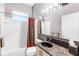 Bathroom with tiled shower, large mirror, and dark granite vanity at 135 Tall Trees Ct, Sarasota, FL 34232
