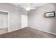 Bedroom featuring neutral tones, plush carpeting, ceiling fan and mounted television at 135 Tall Trees Ct, Sarasota, FL 34232