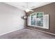 Bedroom featuring plush carpet, ceiling fan, and large shuttered windows offering ample light at 135 Tall Trees Ct, Sarasota, FL 34232