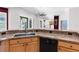 Kitchen counter with granite countertop, stainless steel sink, and dishwasher at 135 Tall Trees Ct, Sarasota, FL 34232