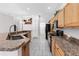 Open kitchen with granite countertops, stainless steel sink, and tiled flooring at 135 Tall Trees Ct, Sarasota, FL 34232