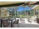 Inviting screened lanai featuring stylish patio furniture and serene views of the backyard and landscaping at 135 Tall Trees Ct, Sarasota, FL 34232