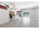 Spacious living room with tile floors and a view into the kitchen and screened patio at 135 Tall Trees Ct, Sarasota, FL 34232