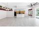 Large open-concept living room with tiled flooring and a view of the kitchen at 135 Tall Trees Ct, Sarasota, FL 34232