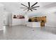 Open-concept living room and kitchen with tiled flooring and recessed lighting at 135 Tall Trees Ct, Sarasota, FL 34232