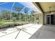 Screened-in patio offers a relaxing outdoor space with views of the lush backyard at 135 Tall Trees Ct, Sarasota, FL 34232
