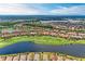 Stunning aerial view of a community with lake, golf course, and beautiful homes with red tile roofs at 13710 Messina Loop # 201, Bradenton, FL 34211