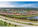 Expansive aerial showcases a well-planned community, with lush greenery, ponds, and manicured landscapes at 13710 Messina Loop # 201, Bradenton, FL 34211