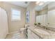 Well-lit bathroom featuring a white vanity, granite countertop, and shower with tub at 13710 Messina Loop # 201, Bradenton, FL 34211