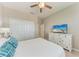 Comfortable bedroom with a plush bed, white furniture, closet, and television at 13710 Messina Loop # 201, Bradenton, FL 34211