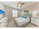 Cozy bedroom featuring a plush bed, white furniture, and plantation shutters at 13710 Messina Loop # 201, Bradenton, FL 34211