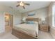 Inviting bedroom with a wooden bed frame, soft bedding, and access to an ensuite bathroom at 13710 Messina Loop # 201, Bradenton, FL 34211
