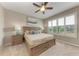 Serene bedroom with a wooden bed frame, plantation shutters, and neutral decor for a calming ambiance at 13710 Messina Loop # 201, Bradenton, FL 34211