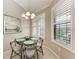 Bright dining area with natural light from shuttered windows and a charming pendant light above a round table at 13710 Messina Loop # 201, Bradenton, FL 34211