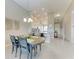 Open concept dining area with decorative lighting adjacent to the kitchen and entrance hallway at 13710 Messina Loop # 201, Bradenton, FL 34211
