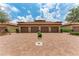 View of home exteriors with garages, lush landscaping and paved driveway at 13710 Messina Loop # 201, Bradenton, FL 34211