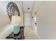 Inviting hallway featuring neutral tones, a decorative mirror, and stylish lighting, leading to the home's entrance at 13710 Messina Loop # 201, Bradenton, FL 34211