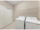 Convenient laundry room with a washer, dryer, and closet at 13710 Messina Loop # 201, Bradenton, FL 34211