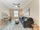 Inviting living room with blue accent rug, couch, and desk area at 13710 Messina Loop # 201, Bradenton, FL 34211
