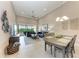 Open concept living room with neutral tones, comfortable seating, and access to a screened patio at 13710 Messina Loop # 201, Bradenton, FL 34211
