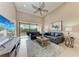 Spacious living room featuring vaulted ceiling, an entertainment center, with an adjacent outdoor view at 13710 Messina Loop # 201, Bradenton, FL 34211