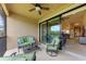 Relaxing screened patio featuring comfortable seating and ceiling fan, perfect for enjoying the outdoors at 13710 Messina Loop # 201, Bradenton, FL 34211