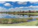 Beautiful community pond reflects blue sky and residences bordering landscaped banks in a stunning Florida setting at 13710 Messina Loop # 201, Bradenton, FL 34211