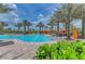 Resort-style pool surrounded by lush landscaping, palm trees, and comfortable lounge chairs at 13710 Messina Loop # 201, Bradenton, FL 34211