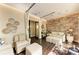Sitting area with elegant furnishings, a decorative stone wall and wood floors at 13710 Messina Loop # 201, Bradenton, FL 34211