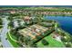 Aerial view of four tennis courts in a well-maintained community with lush landscaping and a playground at 13710 Messina Loop # 201, Bradenton, FL 34211
