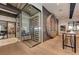 Modern wine room with glass enclosure, decorative wall features, and ambient lighting at 13710 Messina Loop # 201, Bradenton, FL 34211