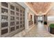 Unique wine storage area showcasing custom cabinetry and a stylish brick ceiling at 13710 Messina Loop # 201, Bradenton, FL 34211