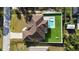 An aerial view showcases the house, pool, green space, and driveway at 14065 Paris Ln, Port Charlotte, FL 33981