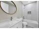 Modern bathroom with a round mirror and a shower-tub combination, designed for relaxation at 14065 Paris Ln, Port Charlotte, FL 33981