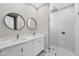 Elegant bathroom featuring dual sinks, modern fixtures, and a glass-enclosed shower at 14065 Paris Ln, Port Charlotte, FL 33981