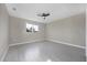 Bright bedroom with a ceiling fan and large window letting in ample natural light at 14065 Paris Ln, Port Charlotte, FL 33981