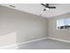 Light-filled bedroom with ceiling fan, window, and neutral paint, ready for personalization at 14065 Paris Ln, Port Charlotte, FL 33981