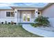 Close up of front door with manicured landscaping and hardscaped walkway at 14065 Paris Ln, Port Charlotte, FL 33981