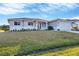 Inviting one-story home showcasing a manicured lawn, fresh landscaping, and a two-car garage at 14065 Paris Ln, Port Charlotte, FL 33981