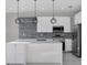 Modern kitchen with quartz countertops, mosaic backsplash, stainless steel appliances, and pendant lighting at 14065 Paris Ln, Port Charlotte, FL 33981