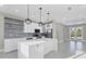 Modern kitchen with quartz countertops, stainless steel appliances, and decorative pendant lighting at 14065 Paris Ln, Port Charlotte, FL 33981