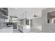 Spacious living room and kitchen with recessed lighting, ceiling fan, and quartz countertops at 14065 Paris Ln, Port Charlotte, FL 33981