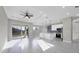 Bright and airy living room featuring recessed lighting, ceiling fan, and sliding doors to the outside at 14065 Paris Ln, Port Charlotte, FL 33981