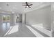 Bright, open-concept living space featuring tile flooring, recessed lighting, and neutral color palette at 14065 Paris Ln, Port Charlotte, FL 33981