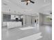 Bright, open-concept living space featuring tile flooring, recessed lighting, backyard access, and modern kitchen at 14065 Paris Ln, Port Charlotte, FL 33981