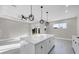 Spacious living room and kitchen with recessed lighting, ceiling fan, and decorative pendant lighting at 14065 Paris Ln, Port Charlotte, FL 33981