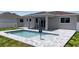This home features a beautiful private pool, surrounded by brick pavers and a manicured lawn at 14065 Paris Ln, Port Charlotte, FL 33981